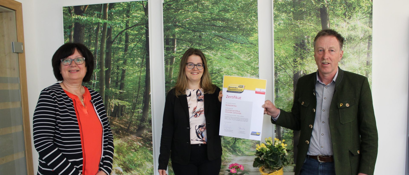 Dieses Bild zeigt v.l.n.r. Mitarbeiterin Adelheid Schicktanz, Arbeitskreisleiterin Verena Aigner und Bürgermeister Martin Voggenberger mit dem Qualitätszertifikat der Gesunden Gemeinde.
